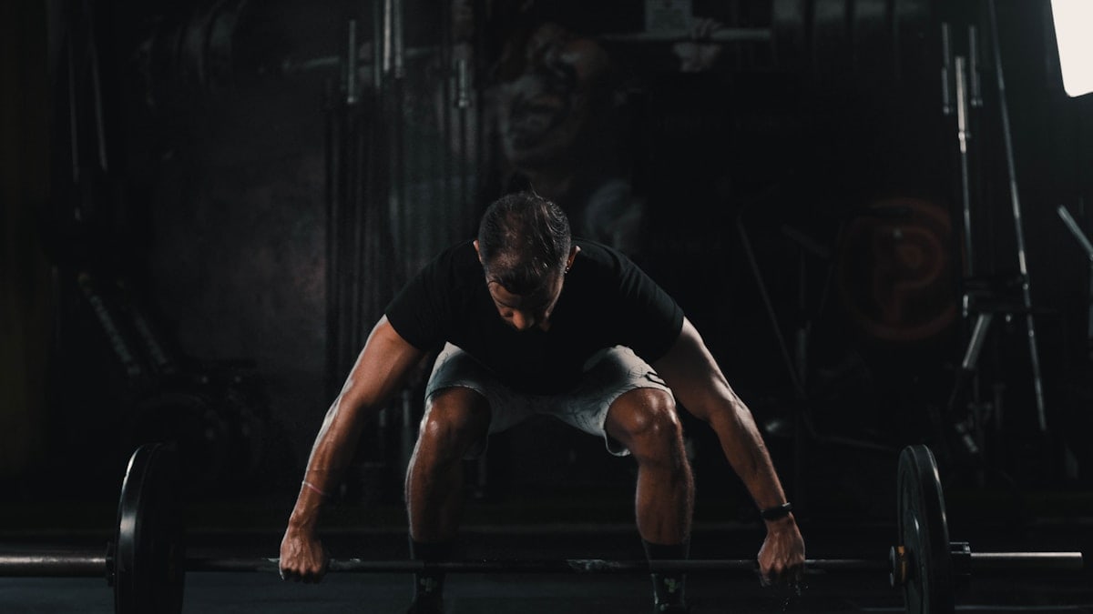 man in black tank top and black shorts doing push up
